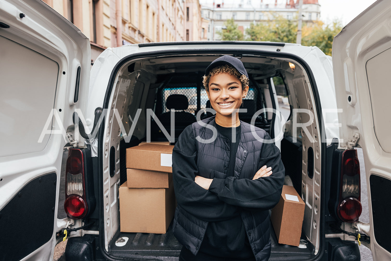 Portrait of a smiling delivery girl wearing a cap and uniform st