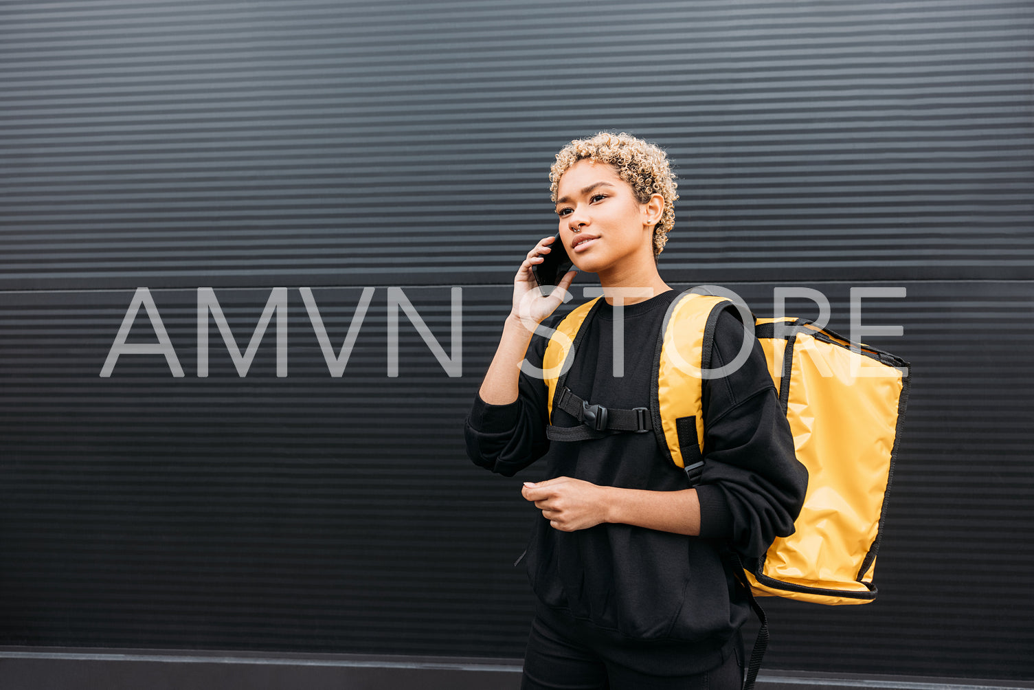 Portrait of a delivery girl with yellow thermal backpack on her