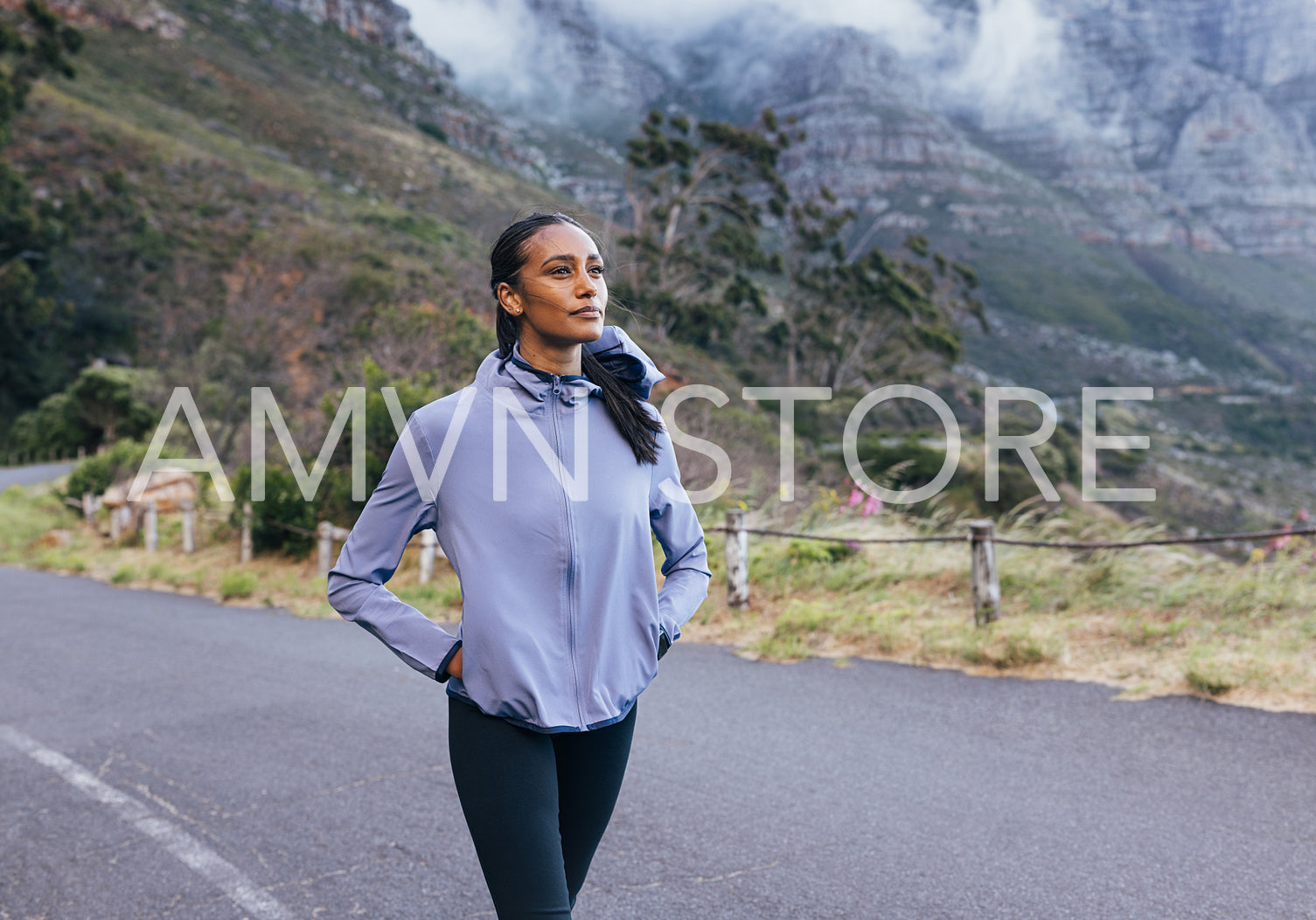 Young slim female in sportswear enjoying the view while walking. Woman doing morning walk in a natural park.