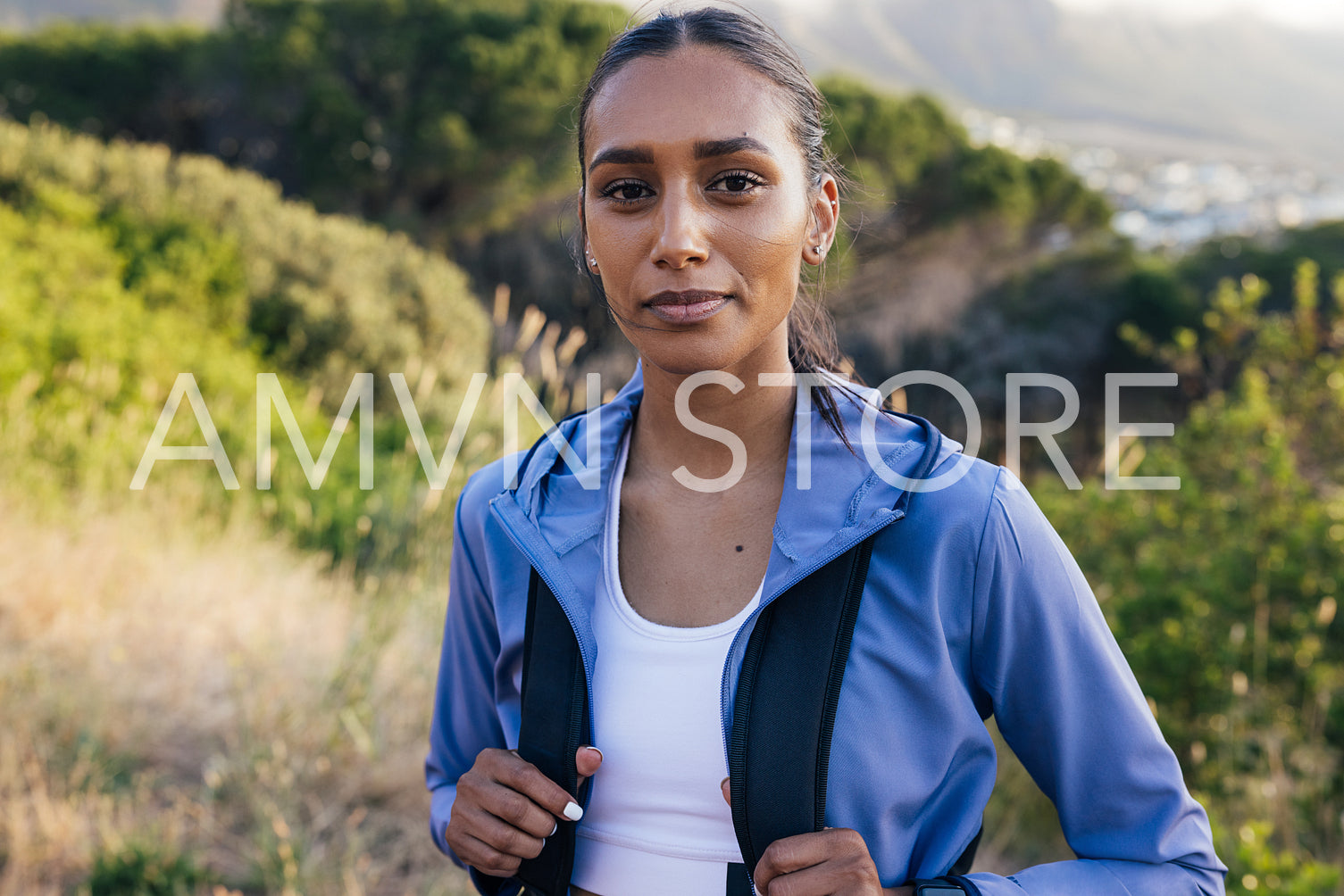 activity, athlete, backpack, beautiful, break, confident, exploration, female, hiking, hill, lifestyle, looking at camera, natural park, one, outdoors, people, person, portrait, real, smiling, sportswoman, standing, sunset, trail run, woman, young