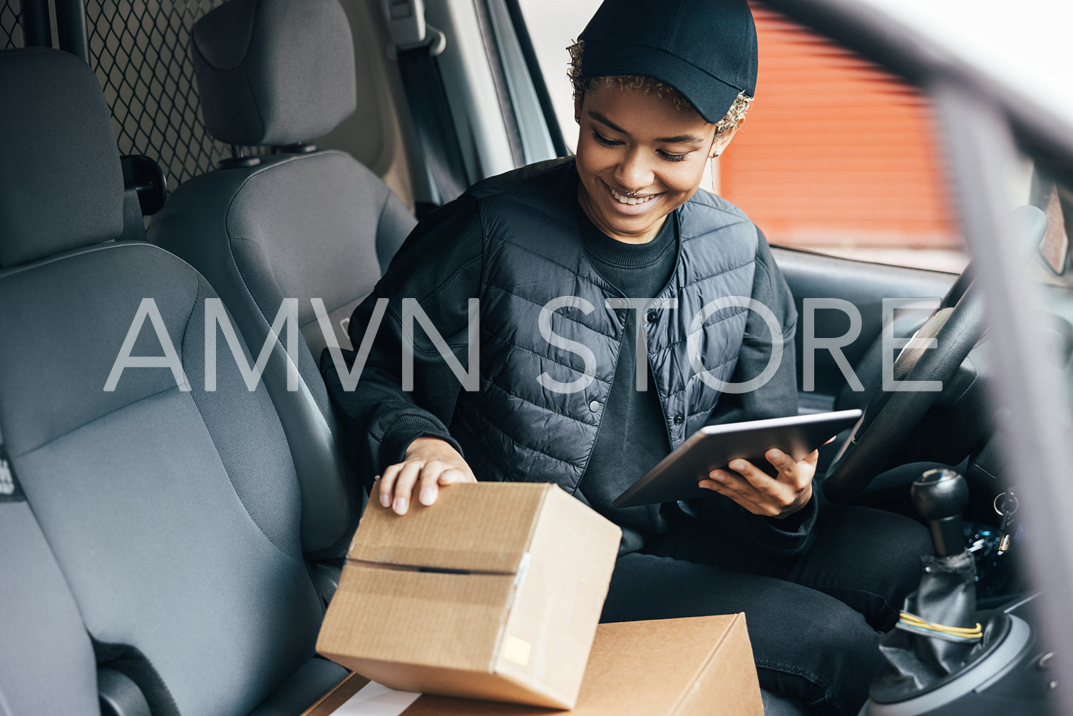 Young smiling woman in uniform checking the package for deliveri