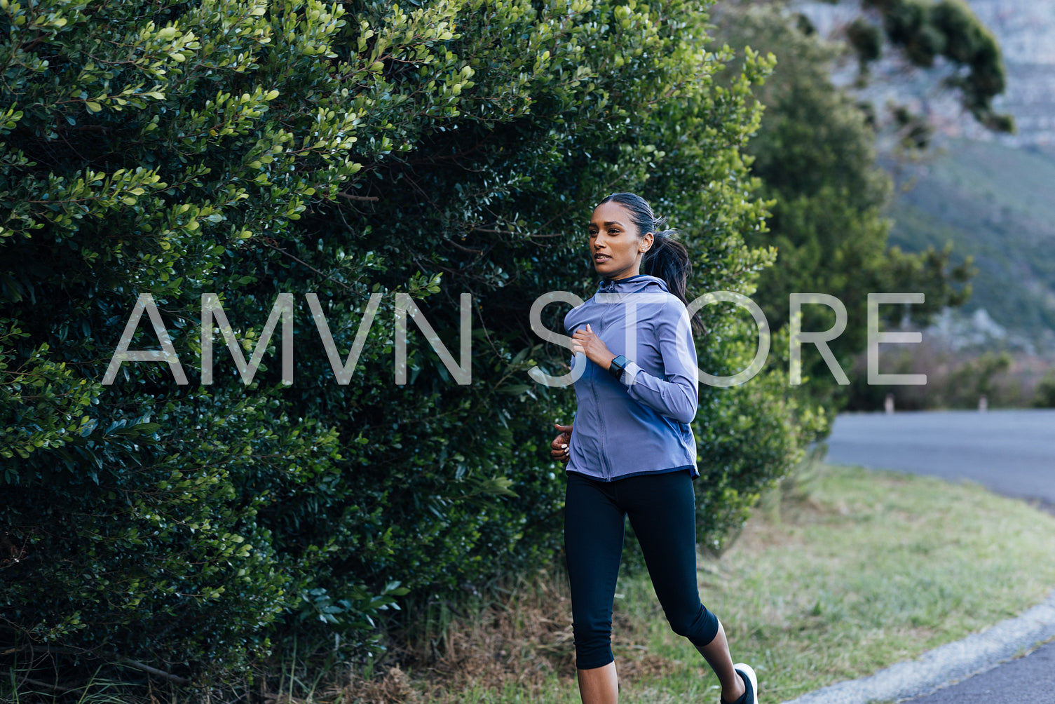 Young female running outdoors in a natural park. Slim female doing an intense run in the morning.