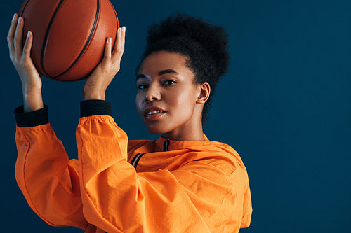 Portrait of a confident professional basketball player posing in studio and looking at camera