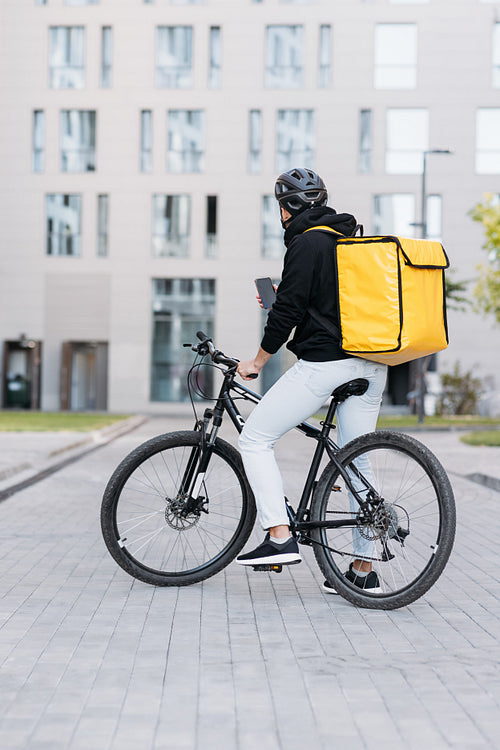 Male courier with a thermal backpack