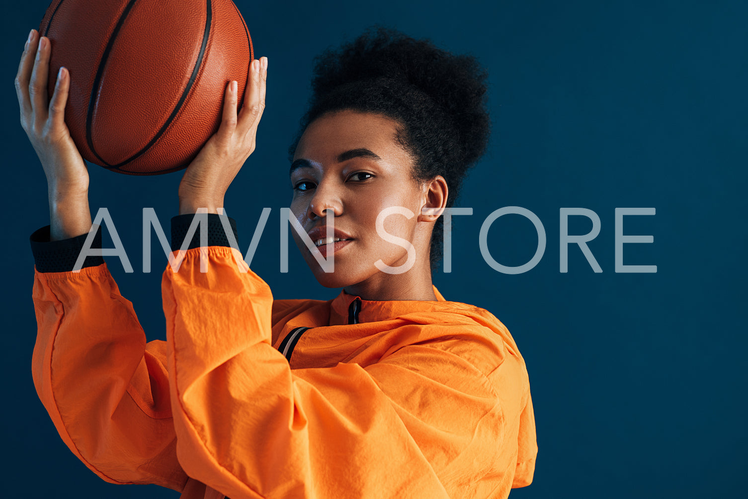 Portrait of a confident professional basketball player posing in studio and looking at camera