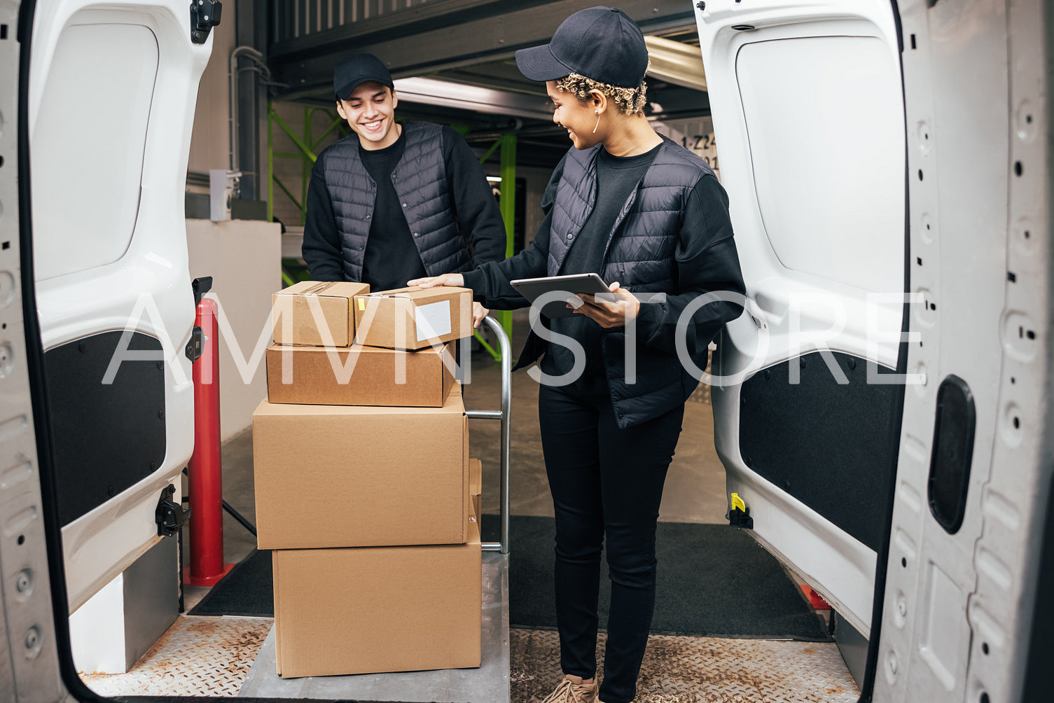 Couriers in uniform working together. People preparing parcels for delivery.