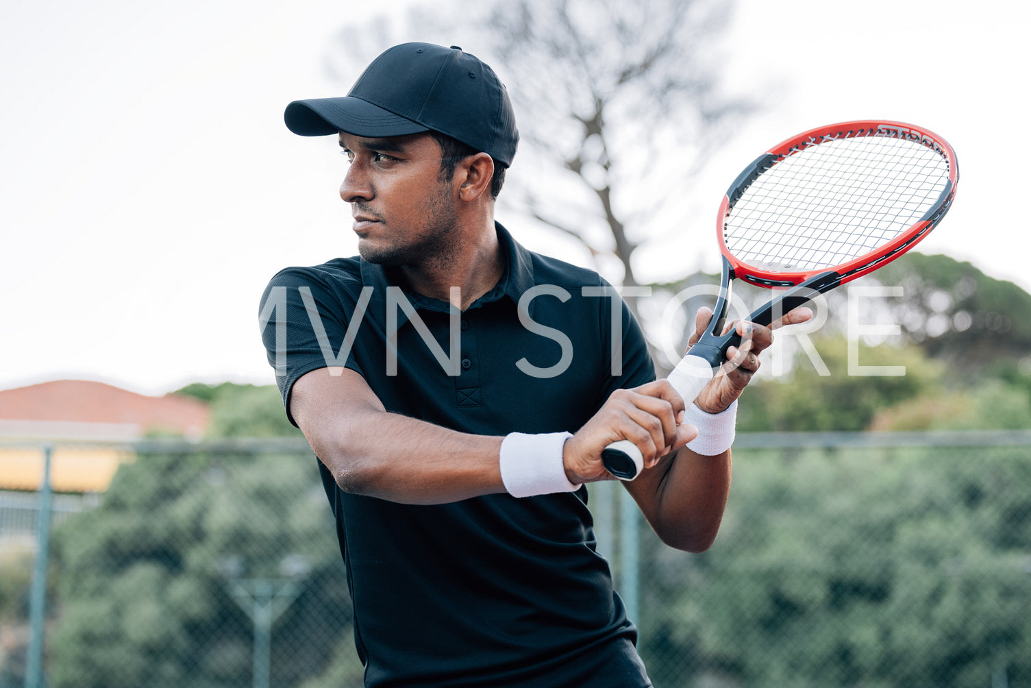 Side view of confident tennis player with racket outdoors