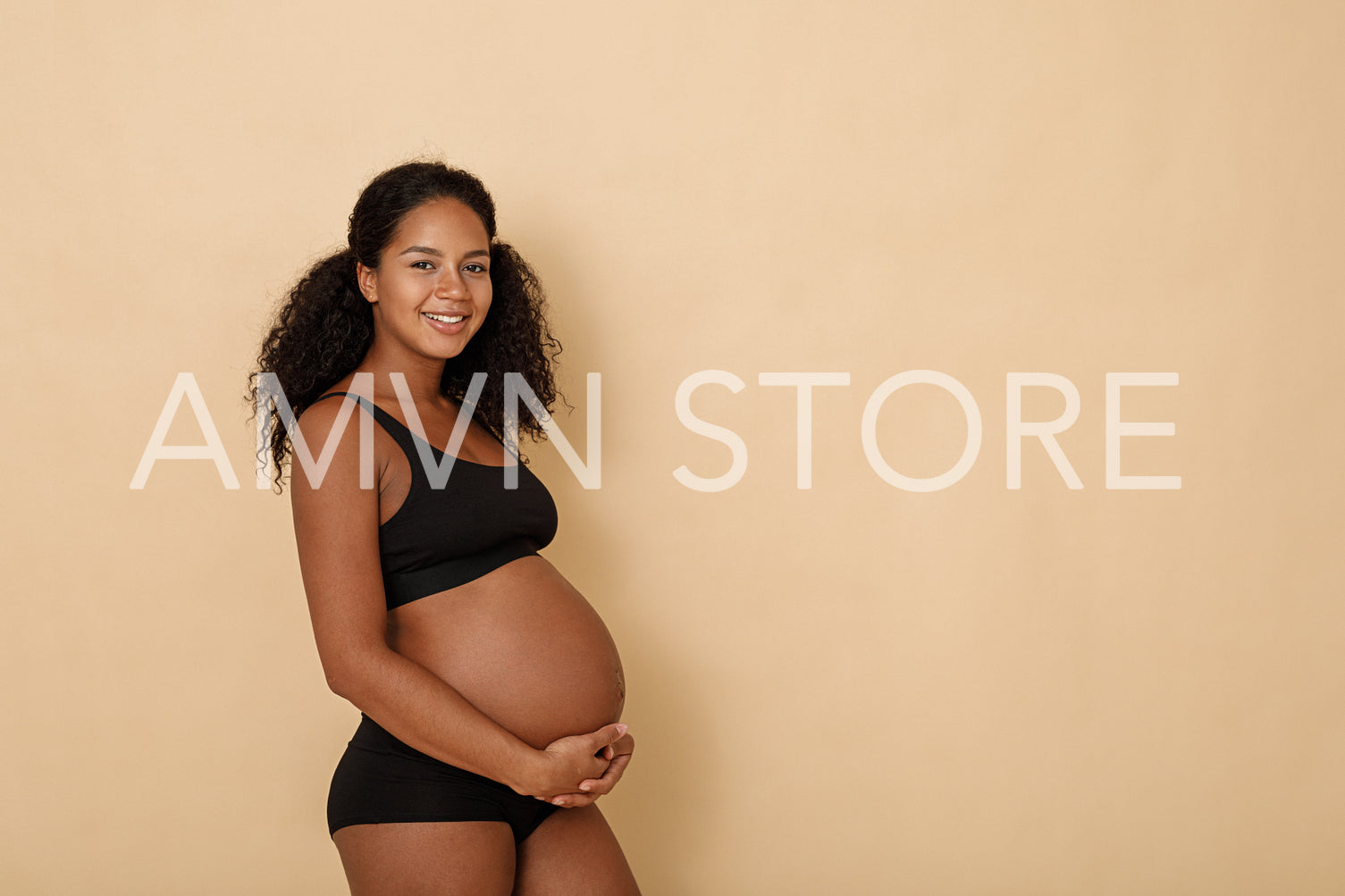 Studio portrait of a beautiful young pregnant woman	