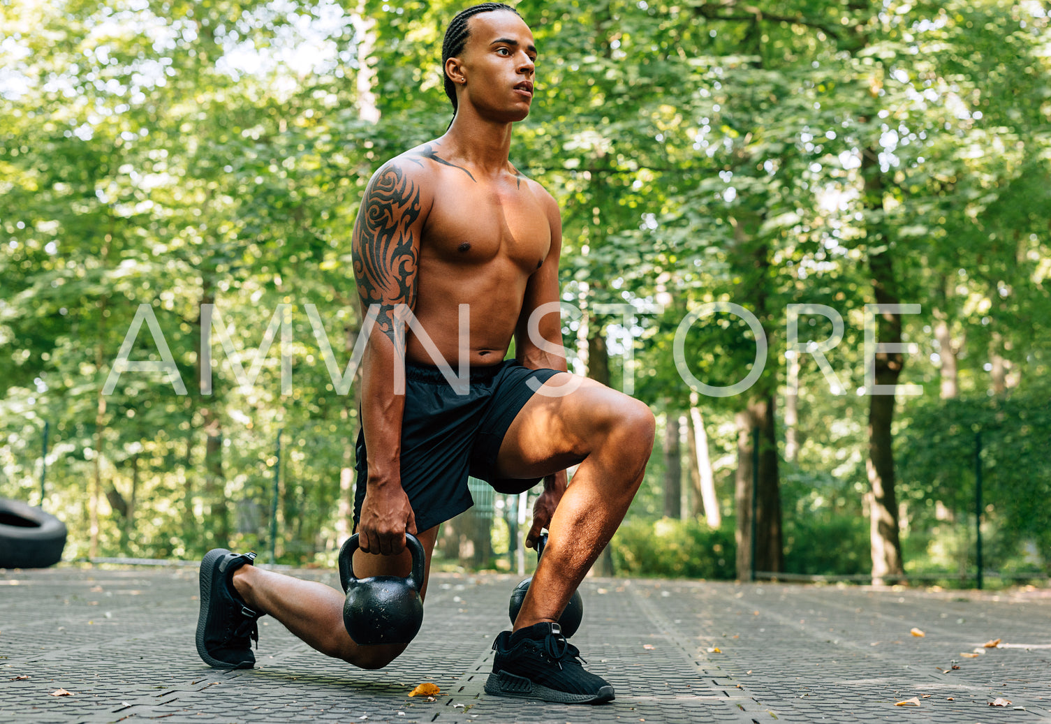 Man exercising with kettlebell outdoors. Athlete doing squats using kettlebells.	