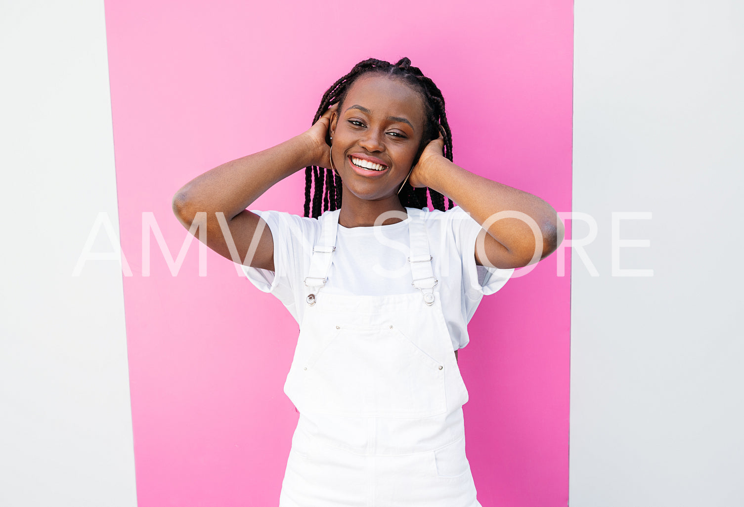 Portrait of a cheerful African American girl adjusting her hair and looking at the camera