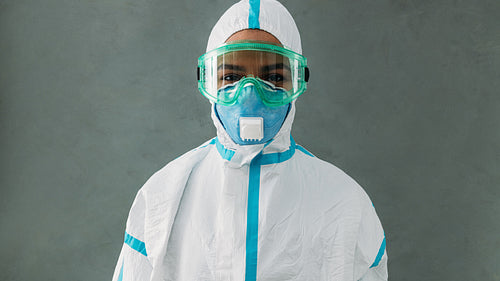 Portrait of a young nurse wearing pandemic suit and respirator