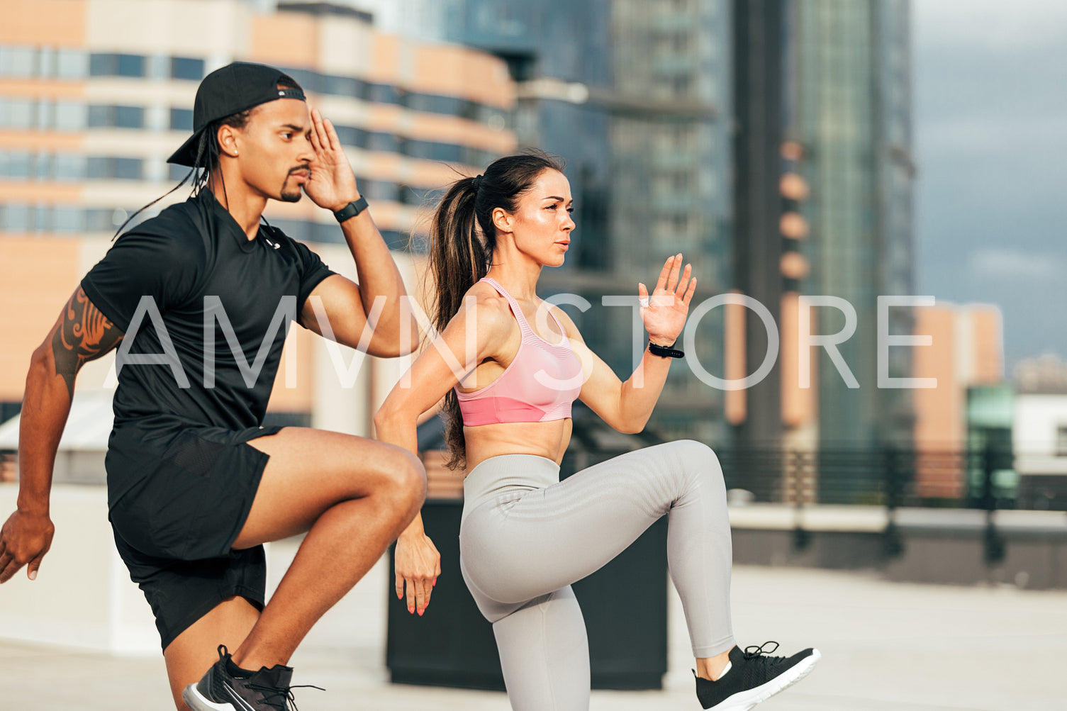 Muscular athletes jumping and running on the rooftop