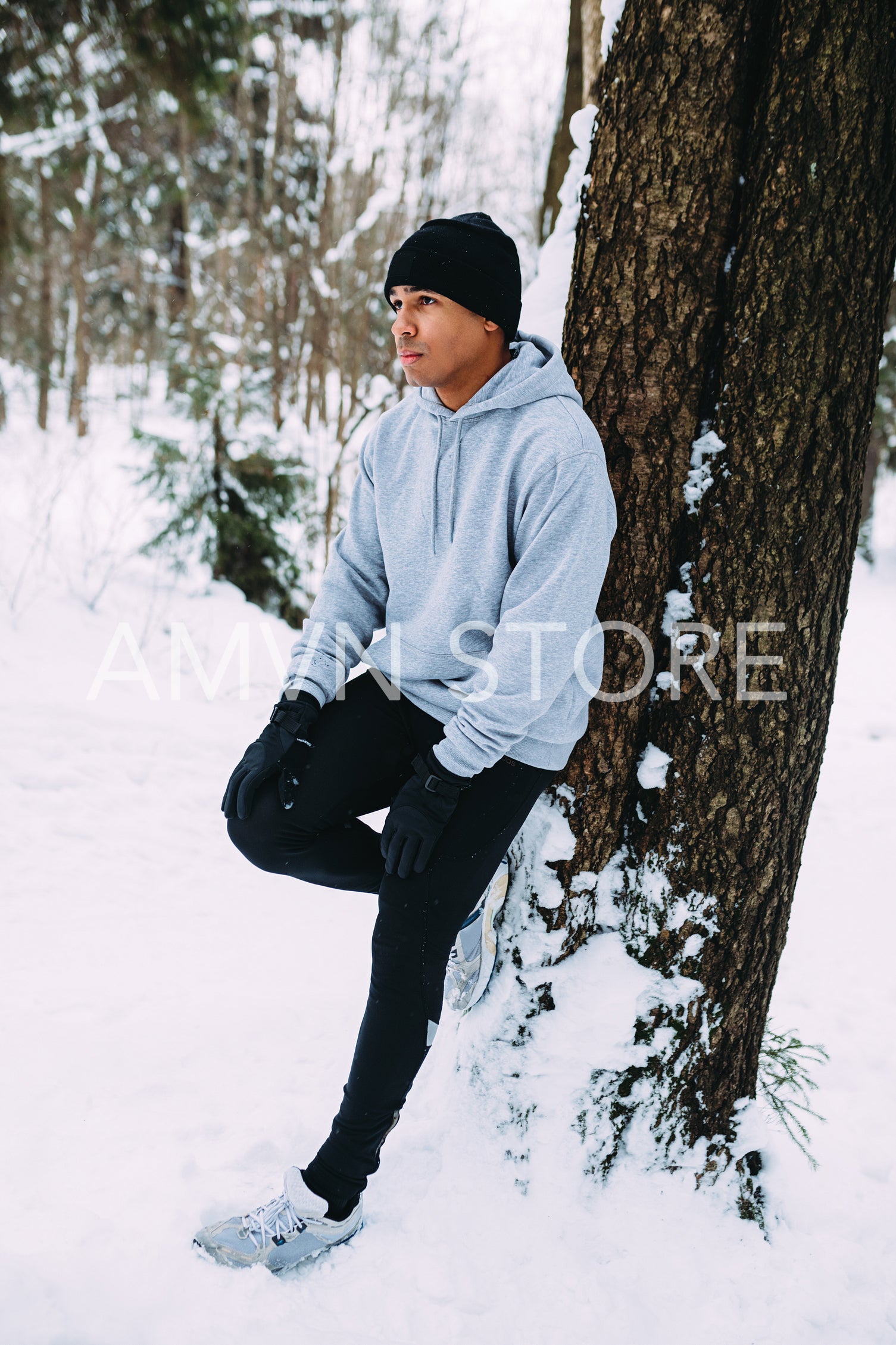 Sportsman relaxing at tree in forest	
