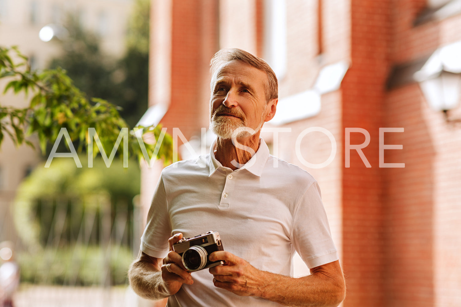 Tourist with the analog camera looking on sightseeing	