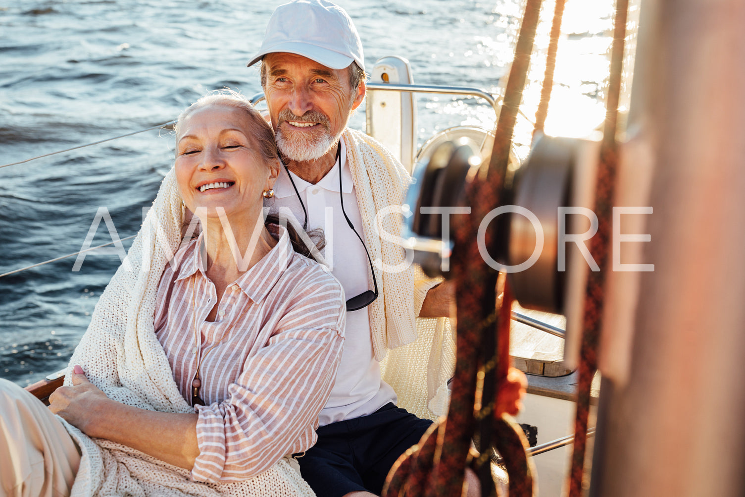 Happy mature couple enjoying their vacation on a sailboat	