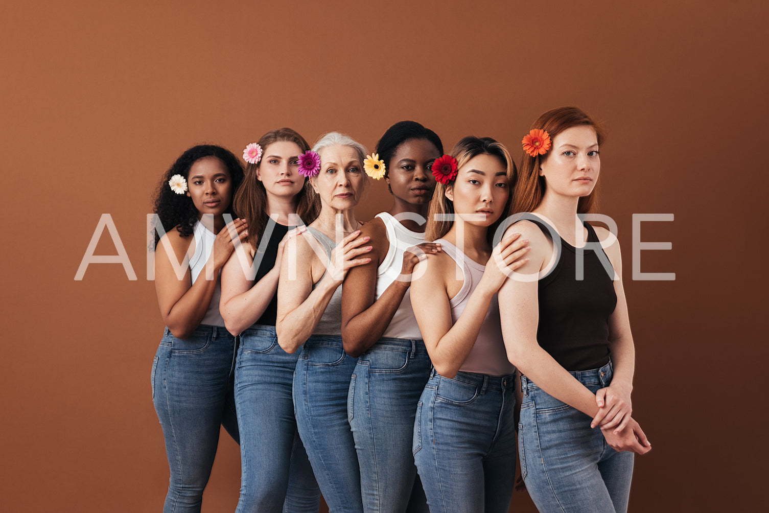 Six diverse female standing together over brown background. Women of different ages with flowers in their hair.