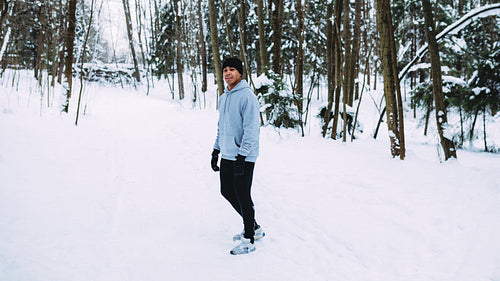 Young sportsman relaxing after training at morning, standing in park