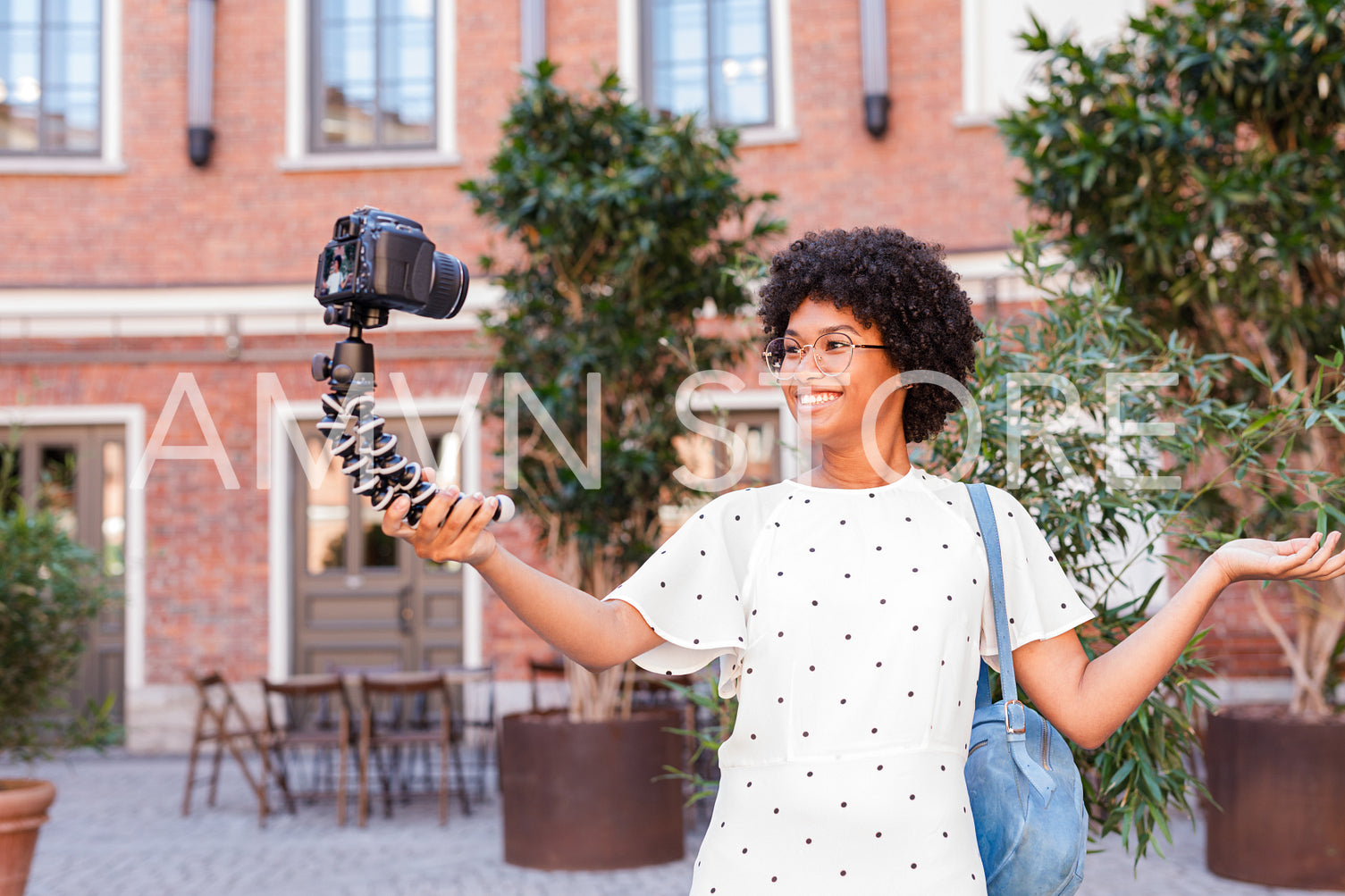 Happy woman shooting video content for her blog	