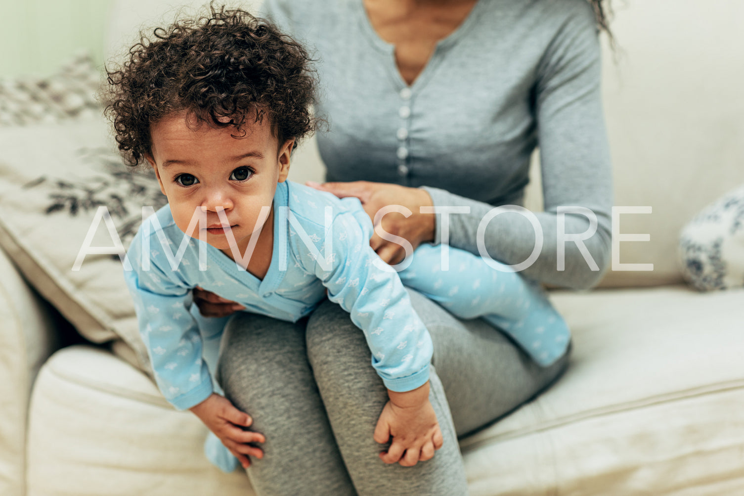 Portrait of a baby boy lying on mother lap	