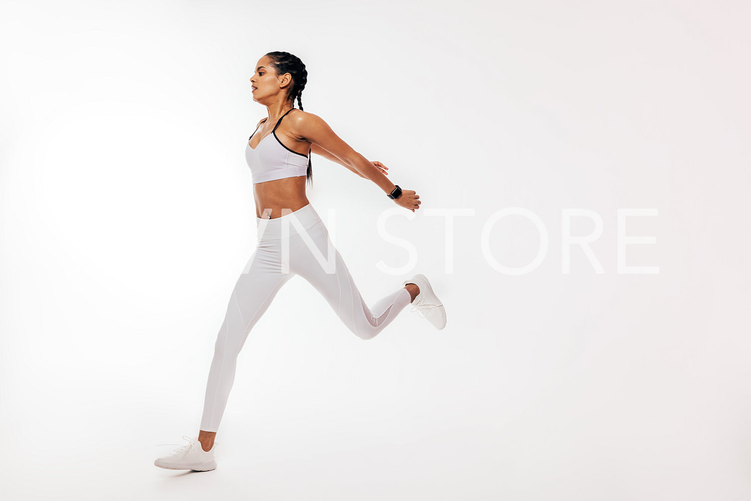 Young mixed race woman running over white background in studio	