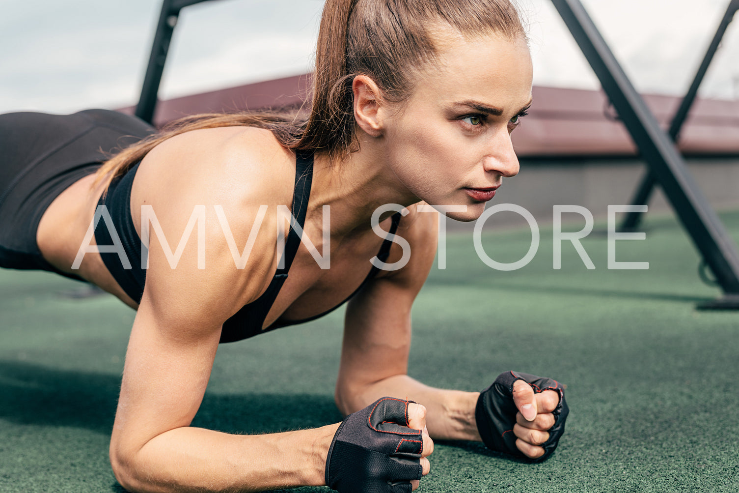 Cropped shot of a young woman doing planking exercise outdoors	
