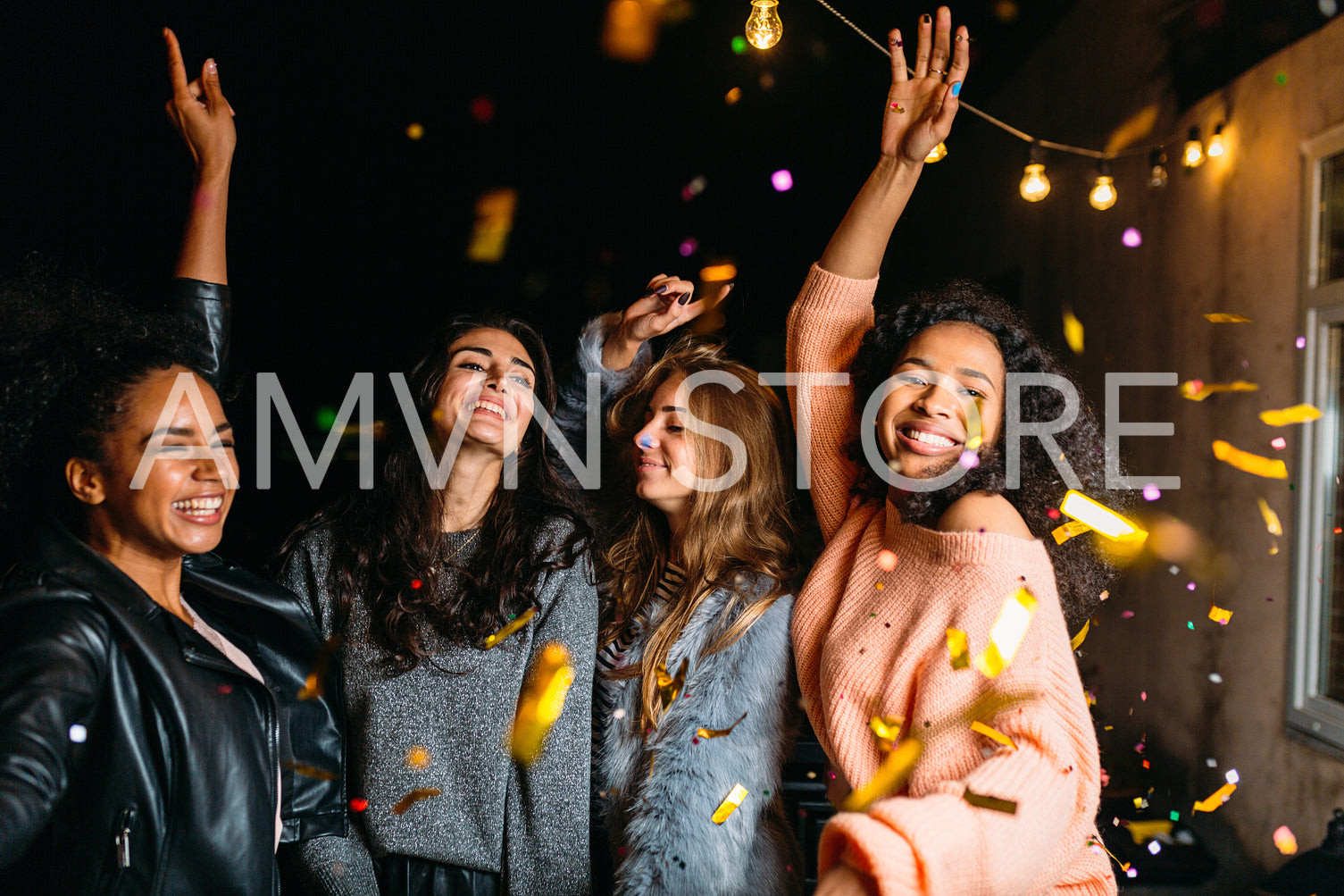 Group of girls dancing at night outdoors. Friends having good times together.	