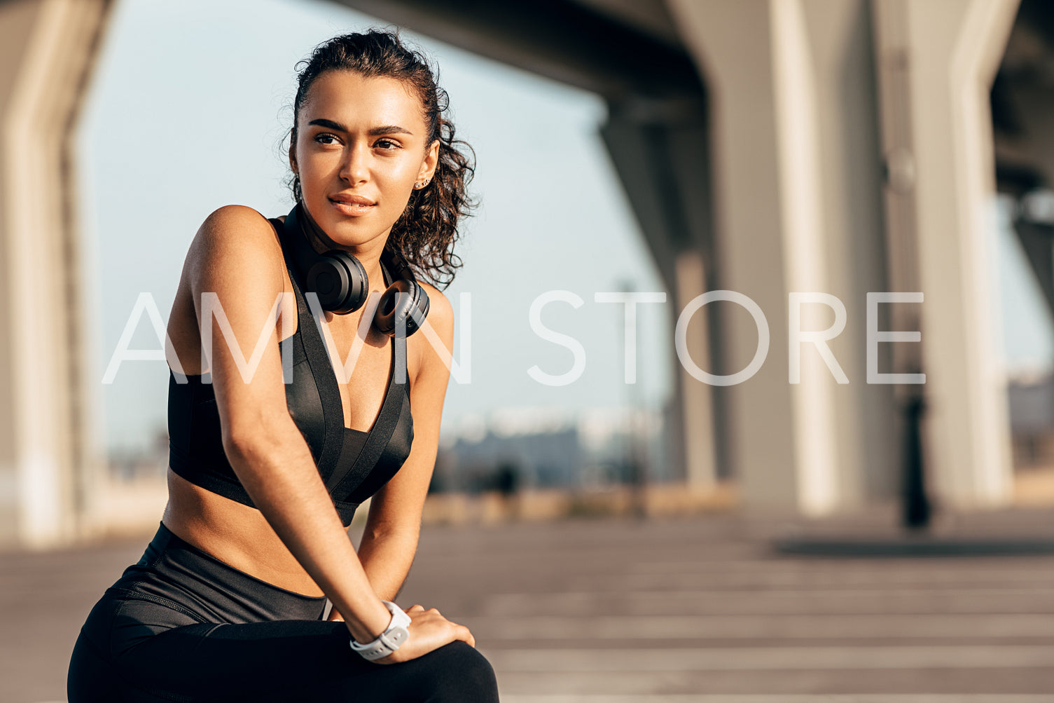 Beautiful fit woman stretching her legs before training	