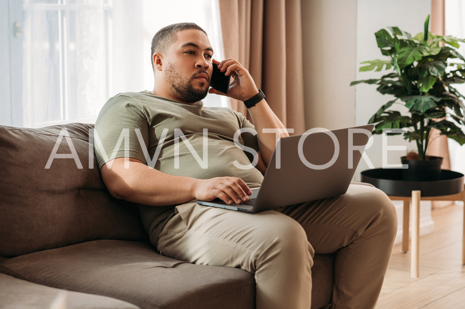 Young man at home working on his laptop