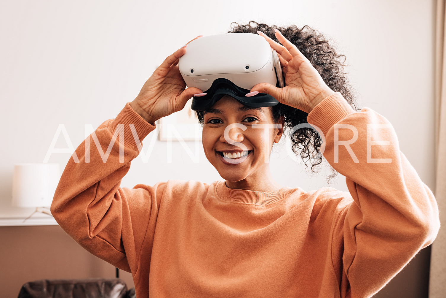 Happy mixed race woman looking at camera wearing VR goggles	