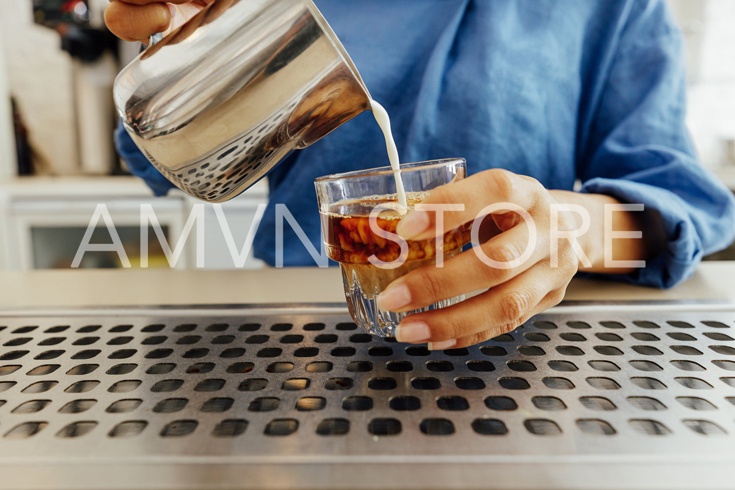 Close up of female barista making a flat white coffee	