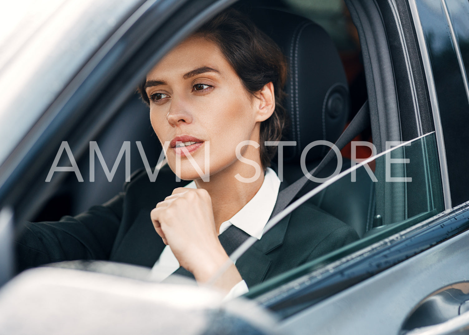 Beautiful businesswoman sitting in a car. Female driver look straight.	