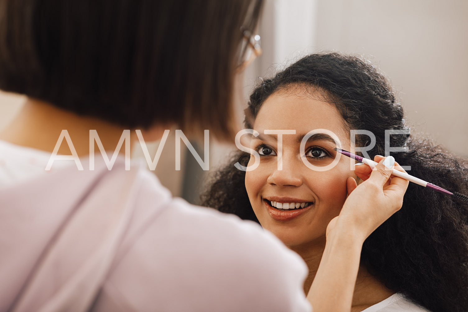 Makeup artist highlighting eyebrows of a model	
