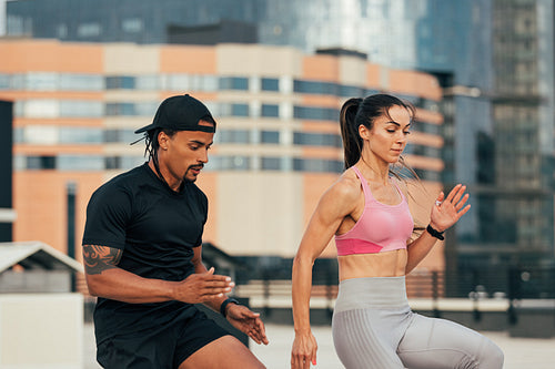 Young athletes doing warming-up exercises on the rooftop