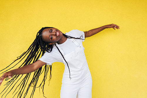 Portrait of a happy woman in casuals with braids enjoying good mood outdoors