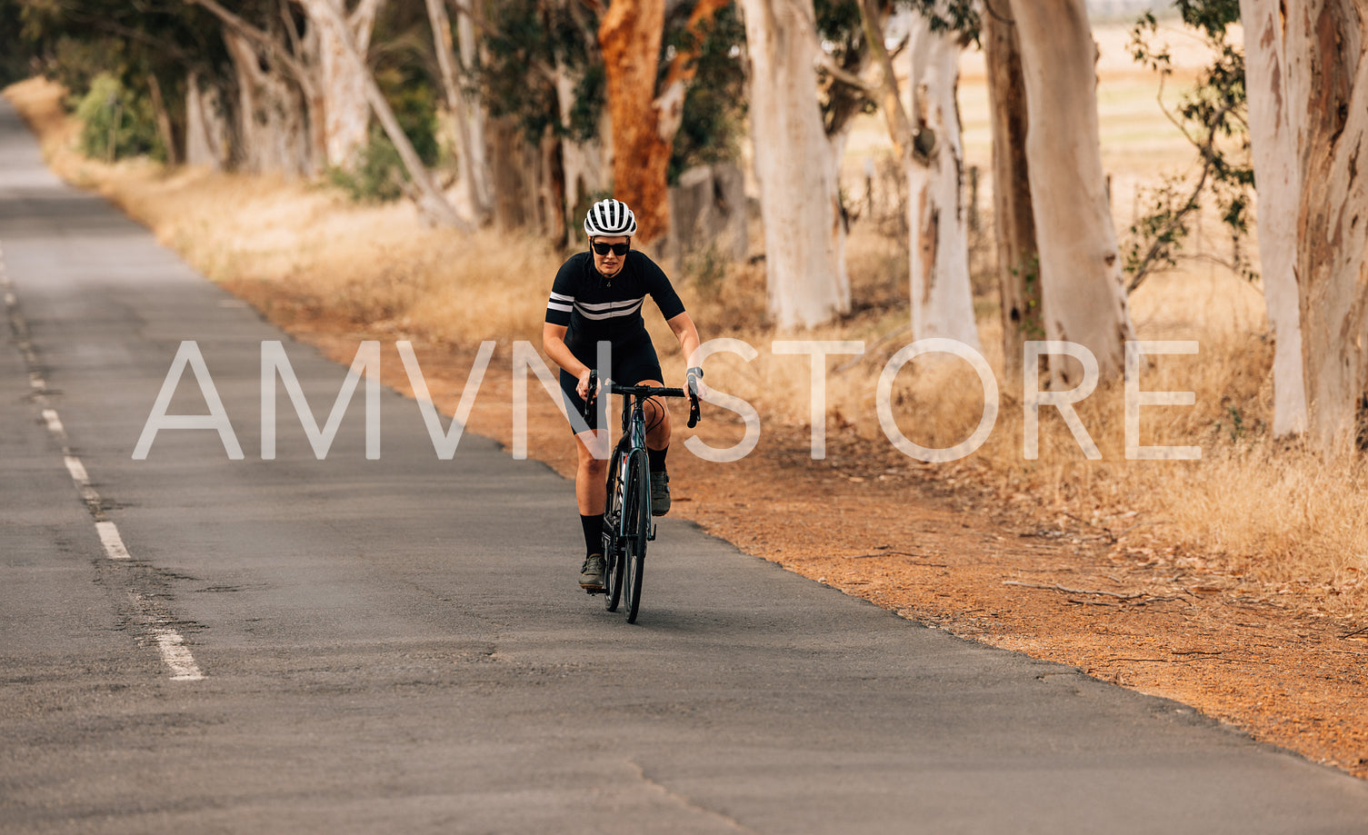 Athletic woman taking a intense bicycle ride on the empty countryside road