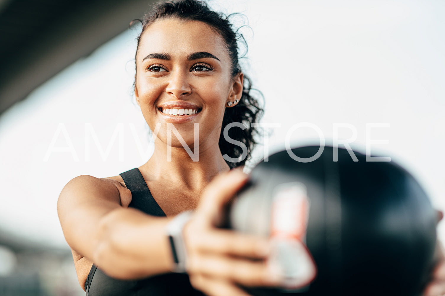 Beautiful woman exercising with fitness ball outdoors. Close up of female athlete exercising at evening.	