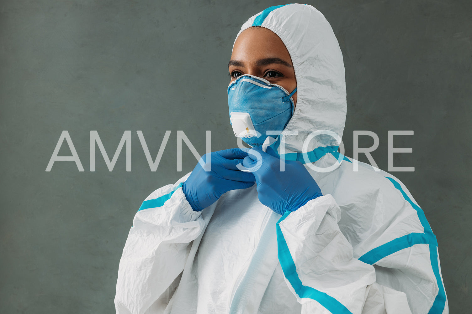 Medical specialist zipping up protective suit preparing for work during a pandemic	