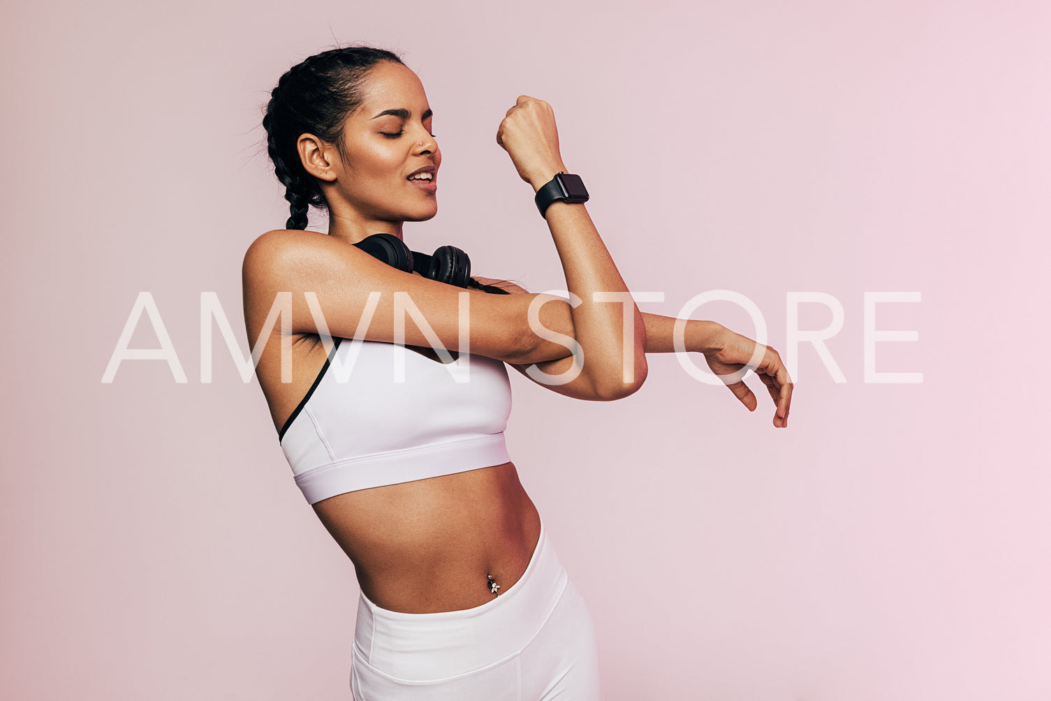 Portrait of a fitness woman stretching her arms in studio