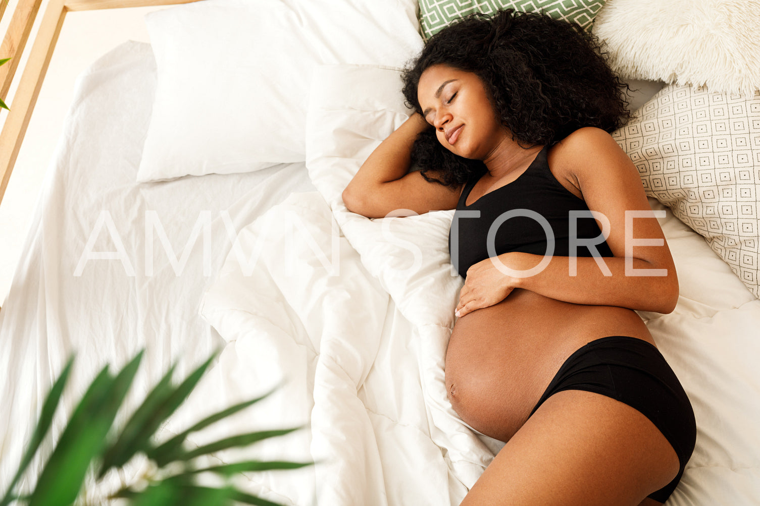 Pregnant woman sleeping in bedroom at home	