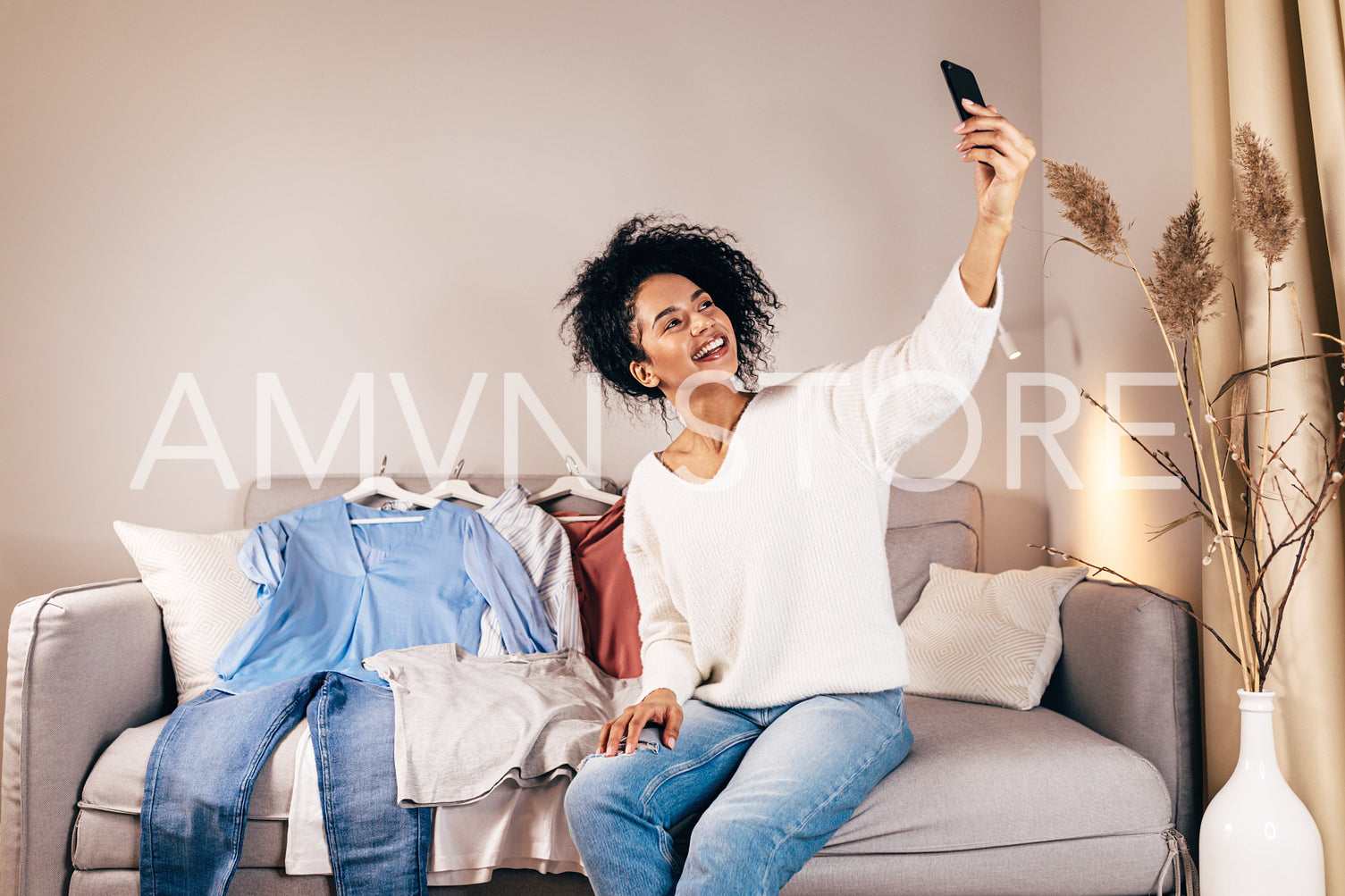 Woman taking a selfie in living room	