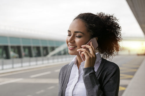 Young woman talking on mobile phone with her eyes closed