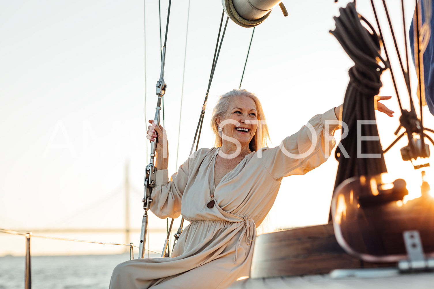 Happy senior woman sitting on a private yacht and pointing way	