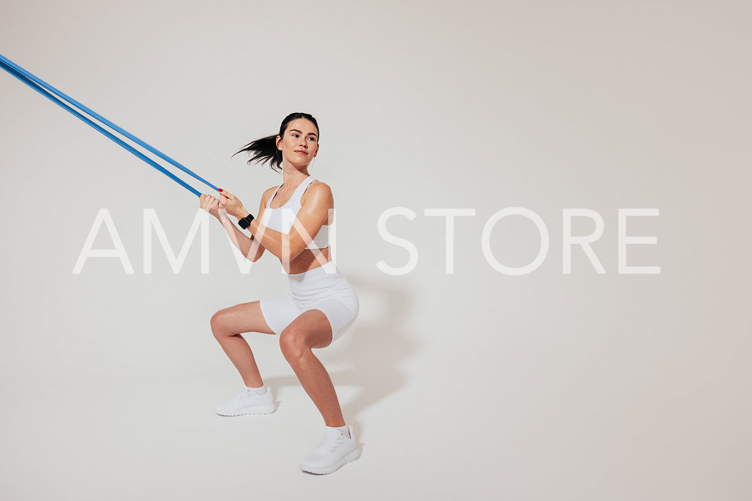 Young slim woman doing sit-ups and using a resistance band