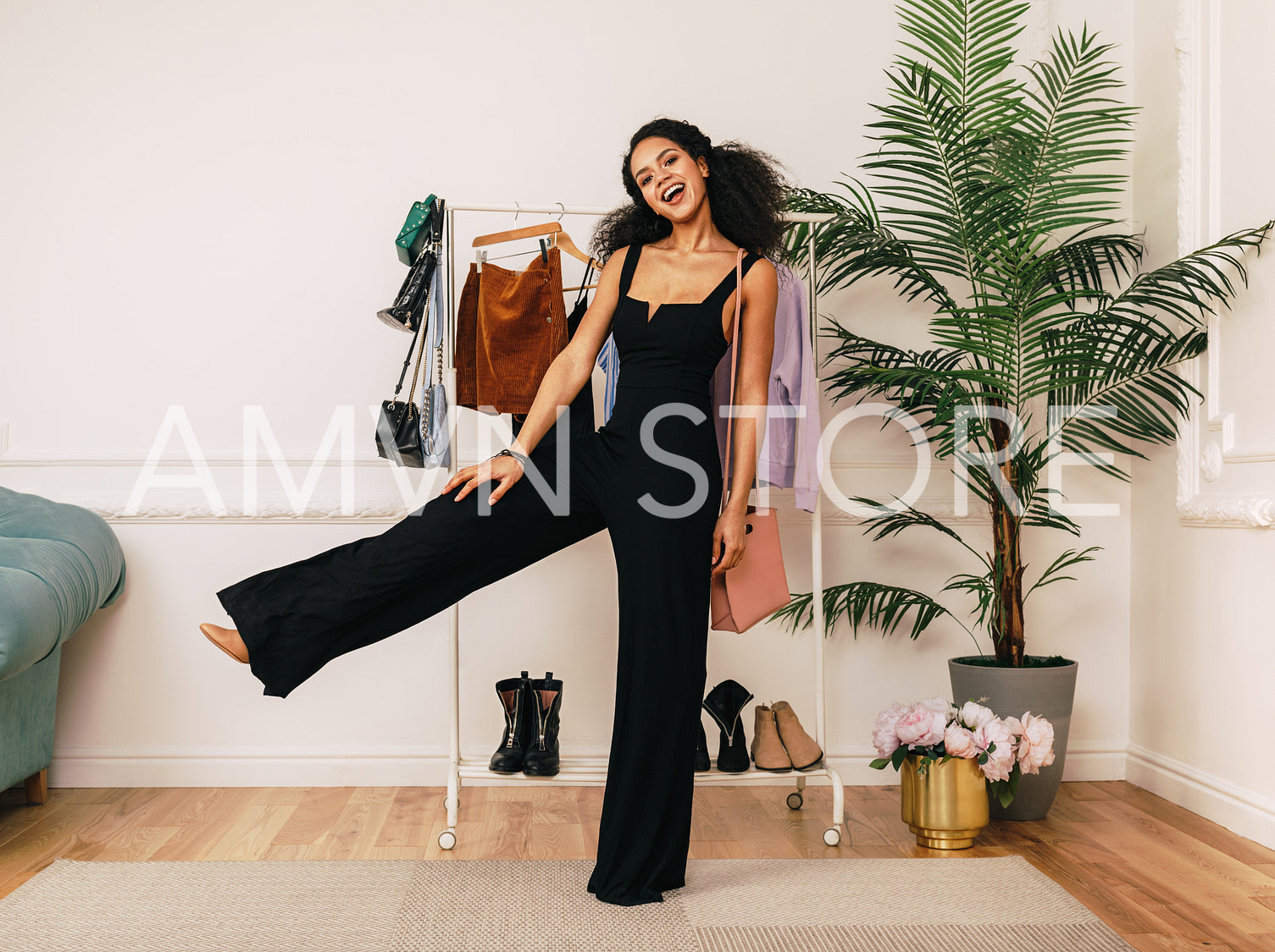 Happy stylist posing in studio. Young buyer standing indoors.	
