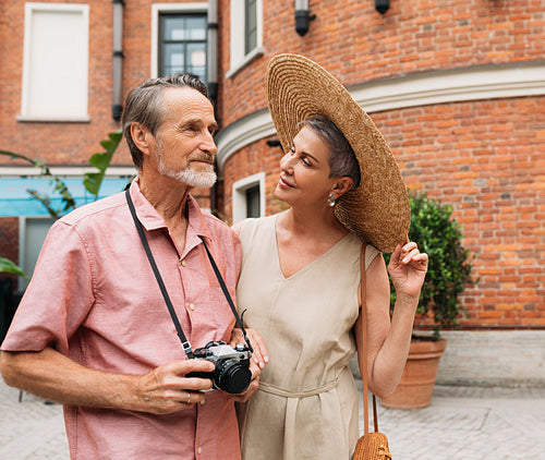 Senior couple walking in the city. Two aged people are on vacation.