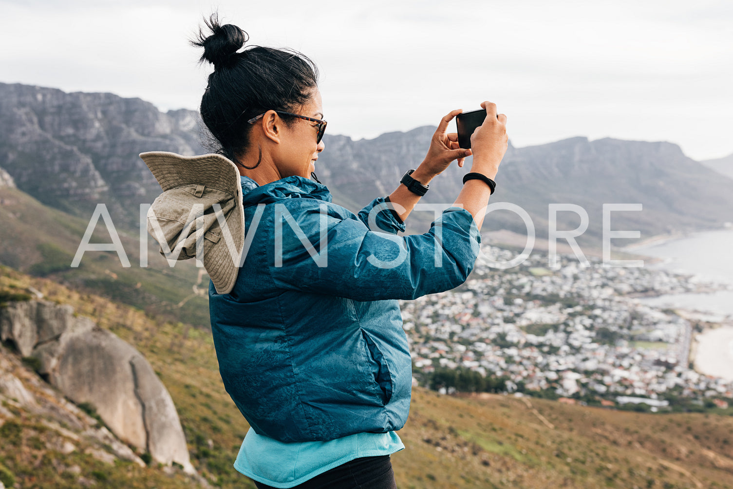 Woman tourist making photographs on mobile phone while hiking