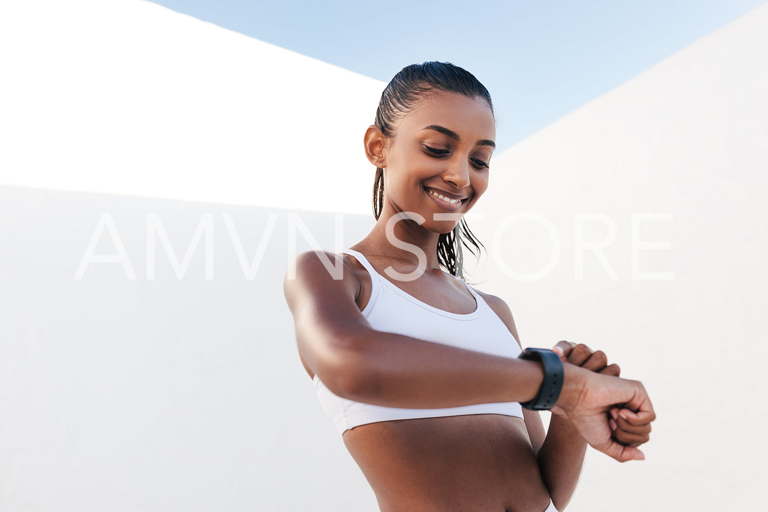 Slim cheerful female checking her pulse