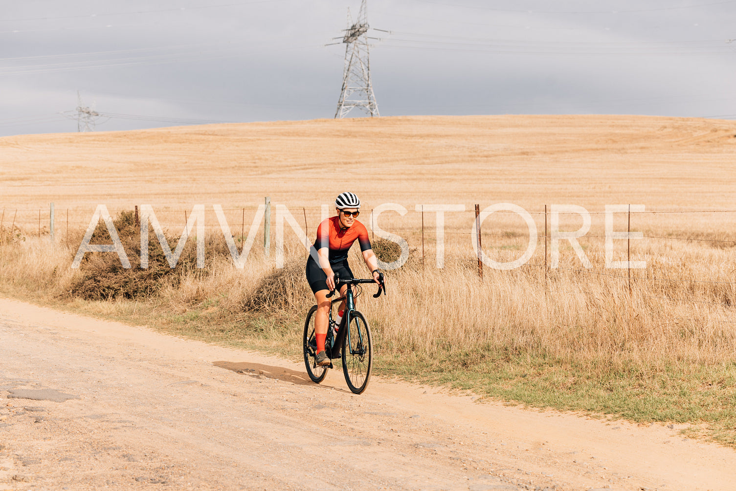 Woman in sportswear on road bike exercising on countryside road