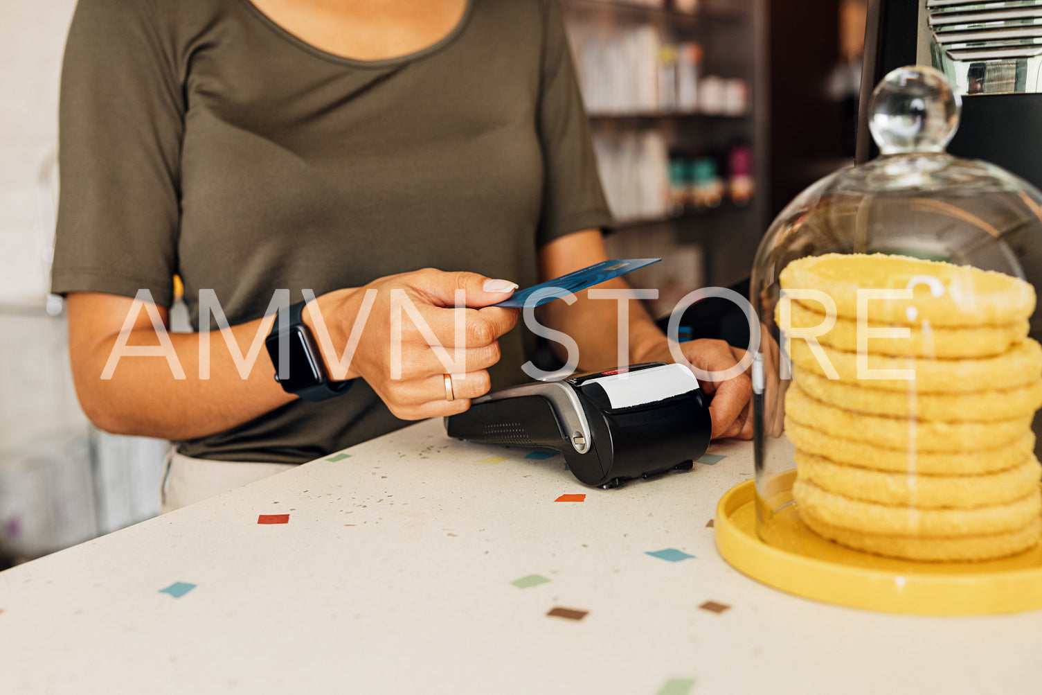 Midsection of unrecognizable female using credit card in cafe	