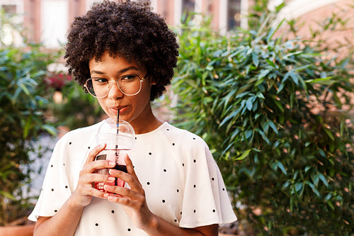 Portrait of a beautiful girl drinking juice with a straw